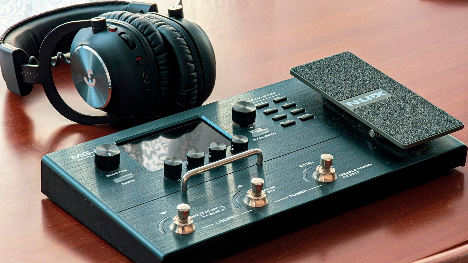A floor multi-effects modeller with headphones resting on it