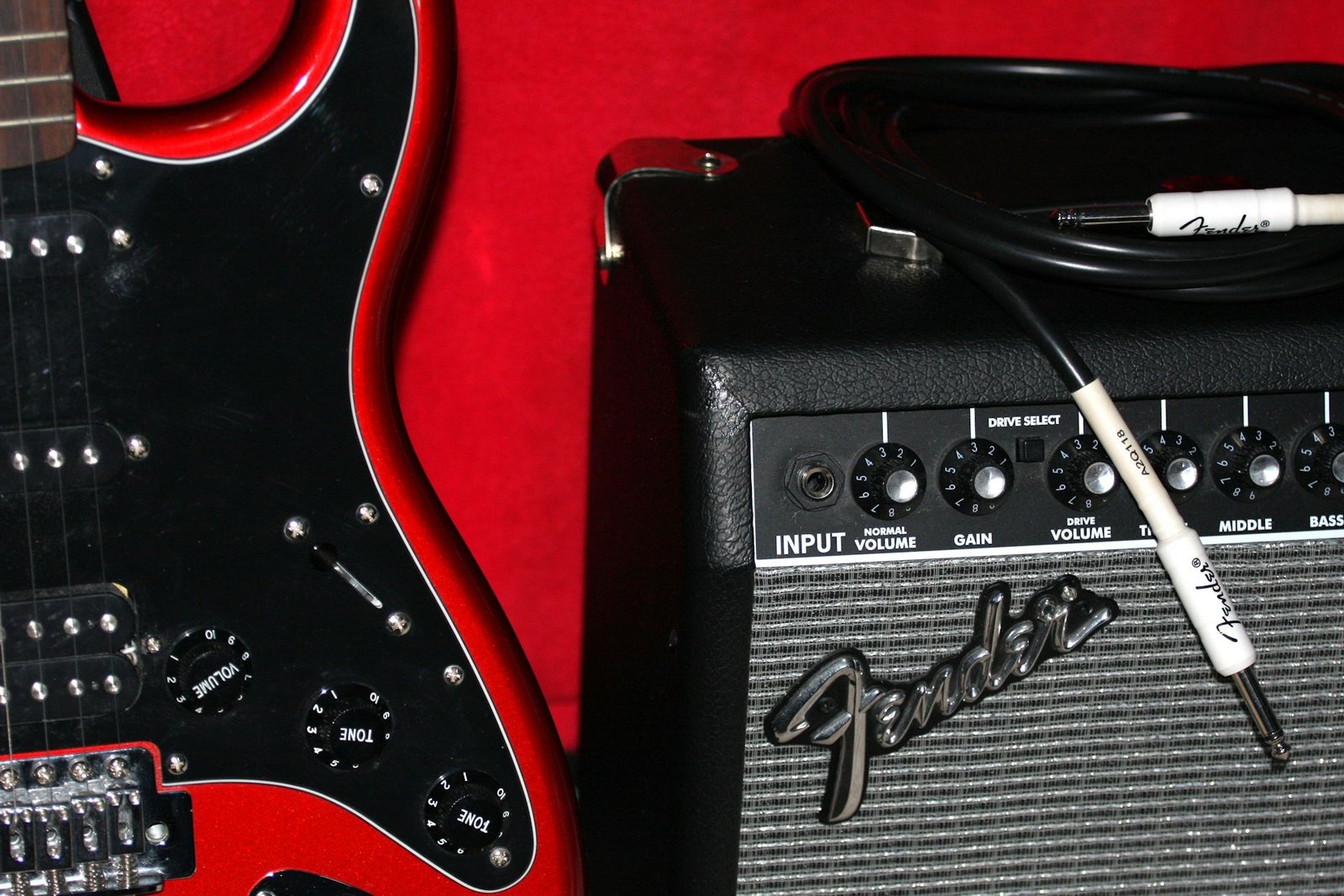 An electric guitar connected to an amplifier with an instrument cable