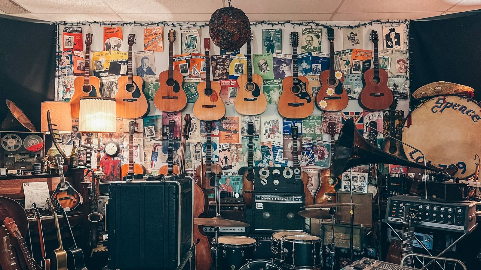 A shop wall filled with guitars and music equipment