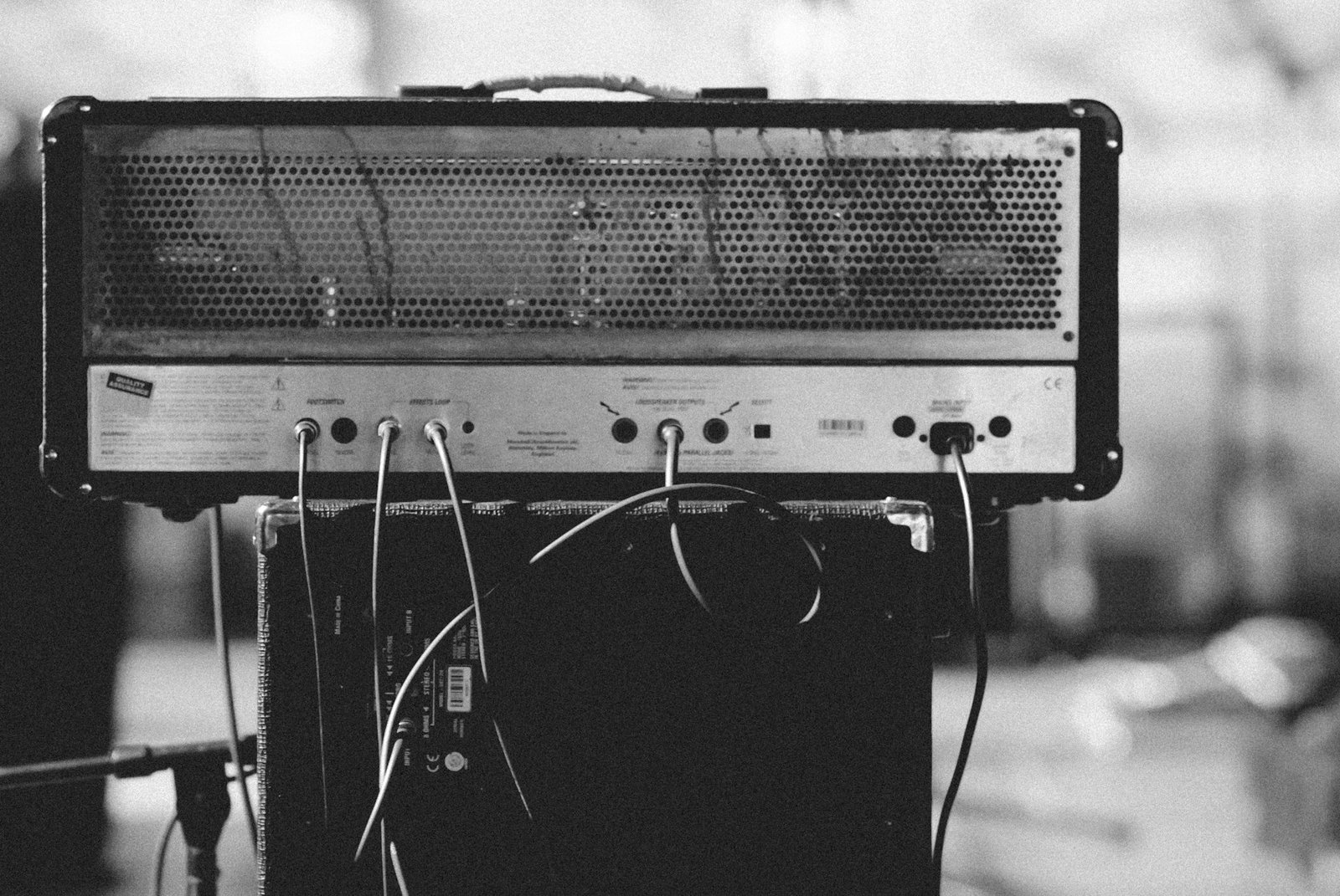 A vintage valve guitar amplifier on top of a speaker cabinet